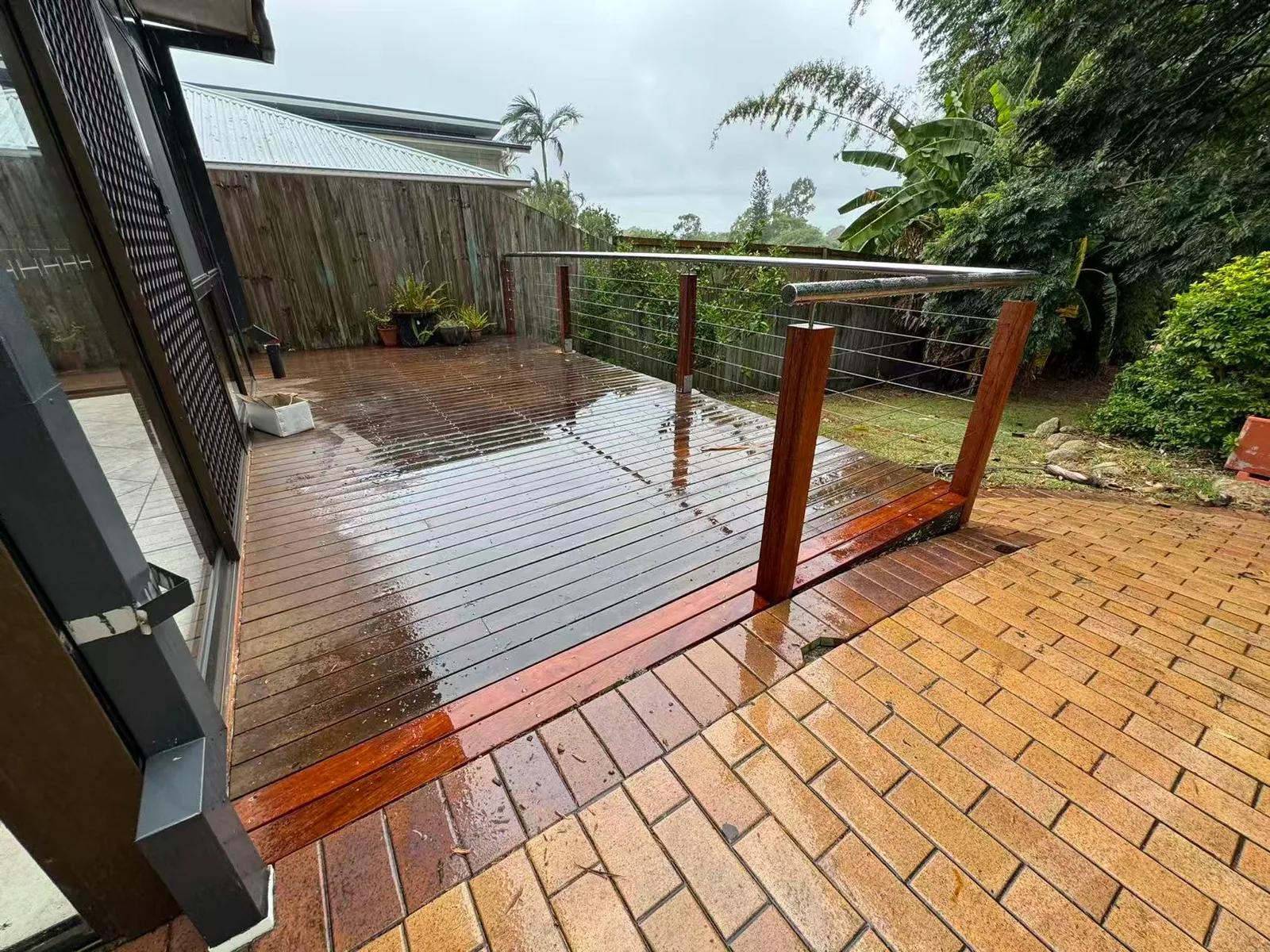 Owner-supplied photo of a timber deck beside a brick outdoor area