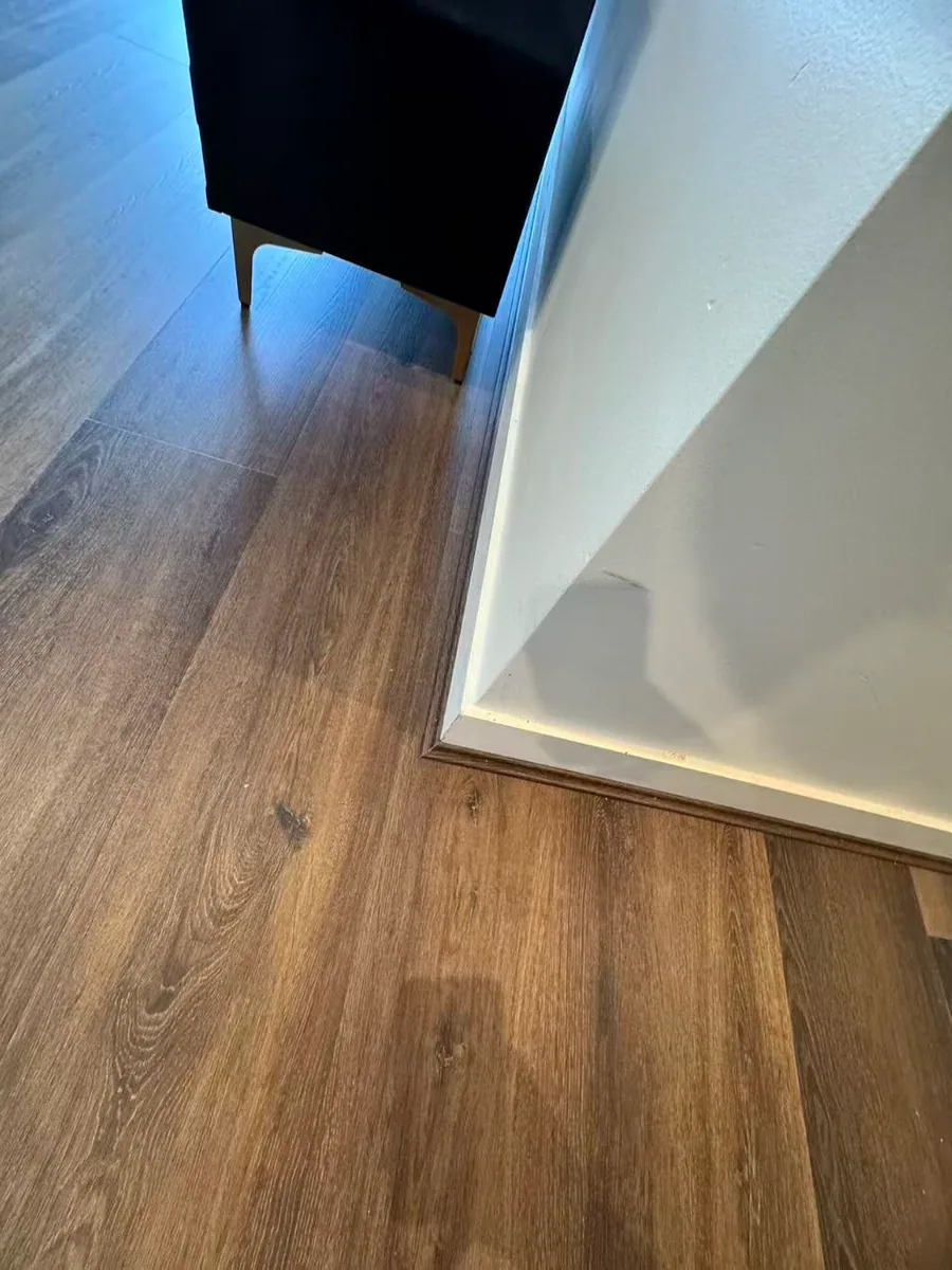 Owner-supplied close photo of a fitted flooring corner