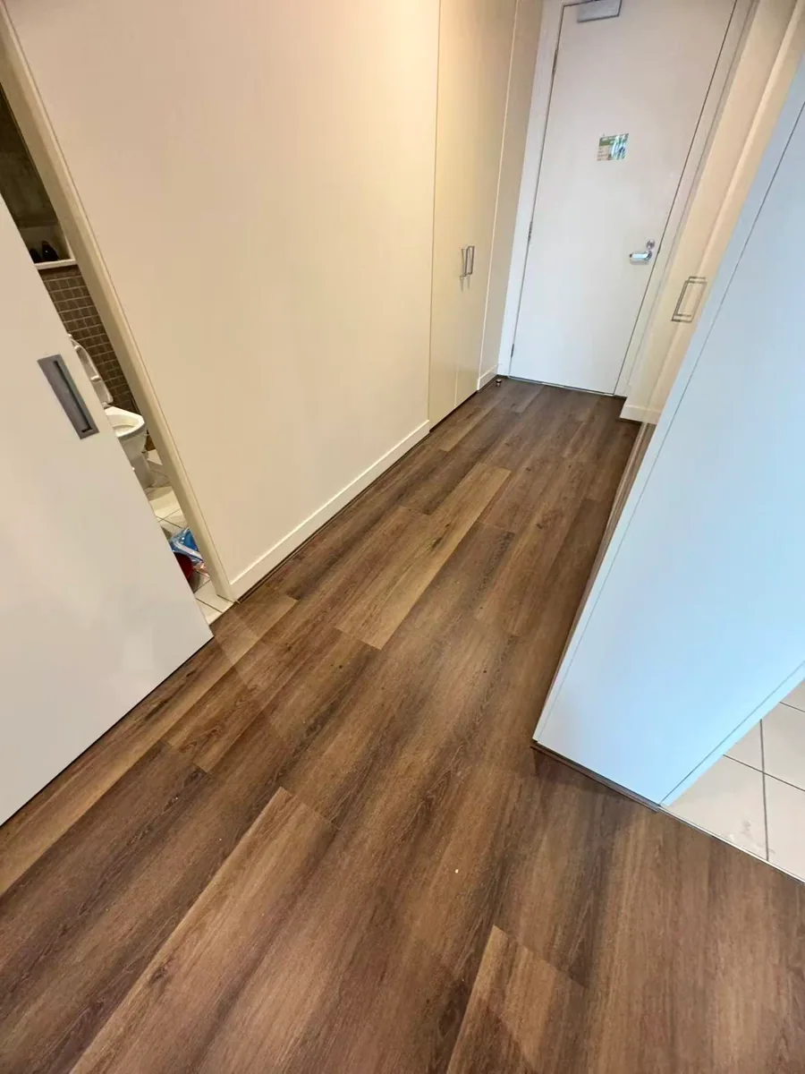 Owner-supplied photo of a finished flooring entry and wall junction