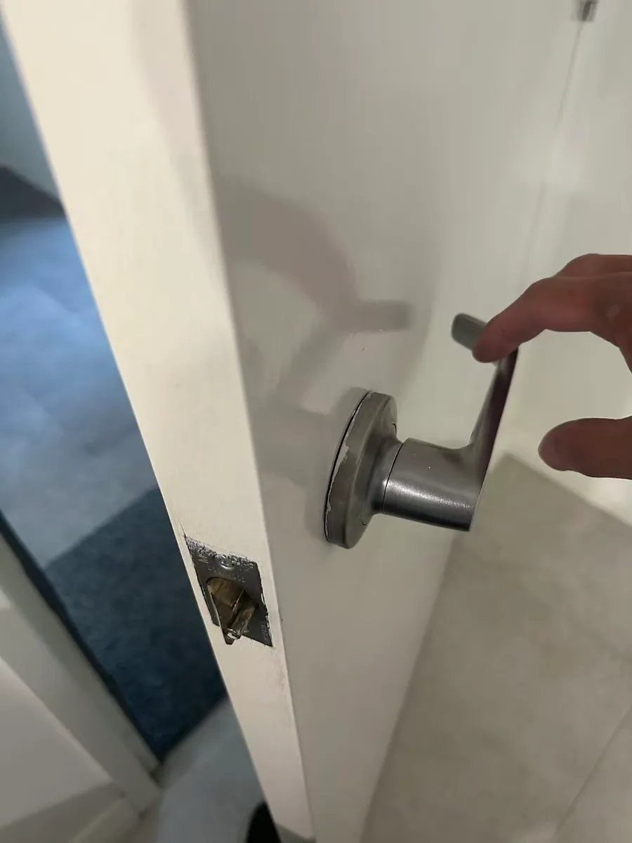 Owner-supplied close photo of front-door hardware being checked