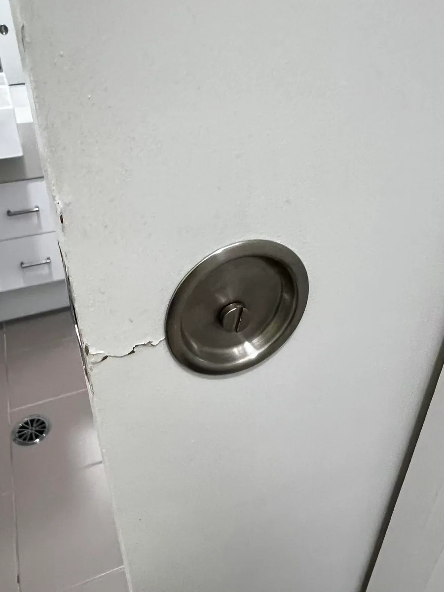 Owner-supplied close photo of a sliding-door roller fitting