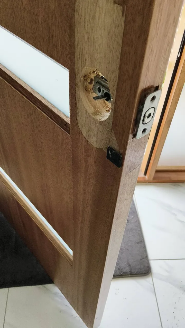 Owner-supplied close photo of timber door preparation around a lock opening