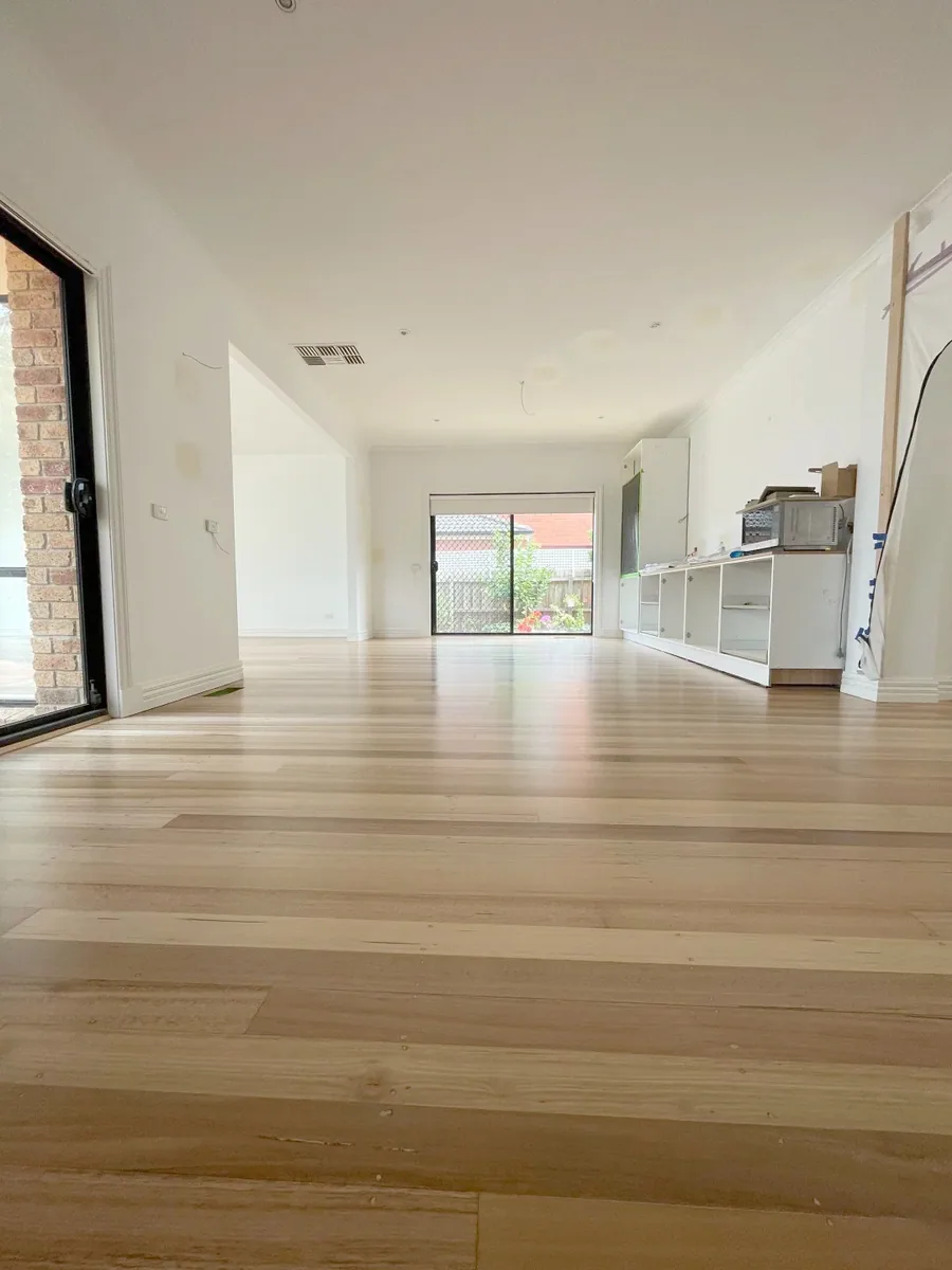 Owner-supplied photo of timber flooring across an open-plan interior